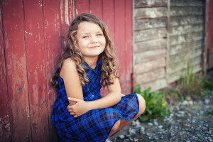 Girl against an old red door, Family photography by Eric Pearce Photography